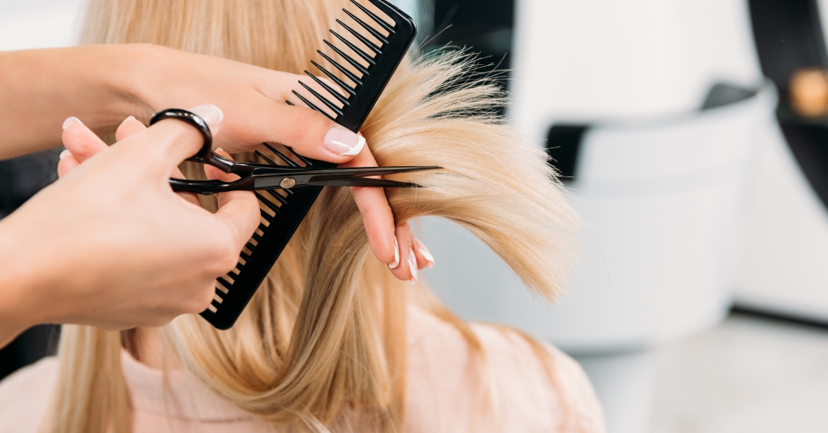 hairdresser trimming blonde hair