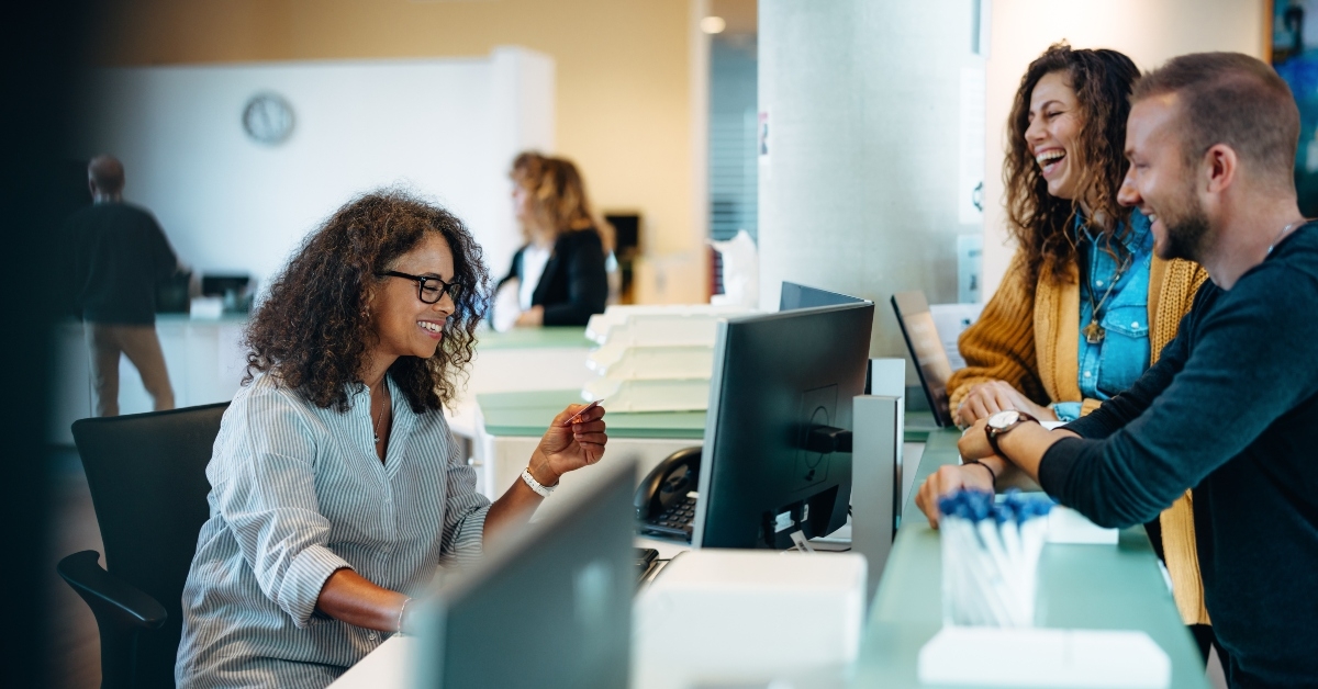 receptionist assisting people 