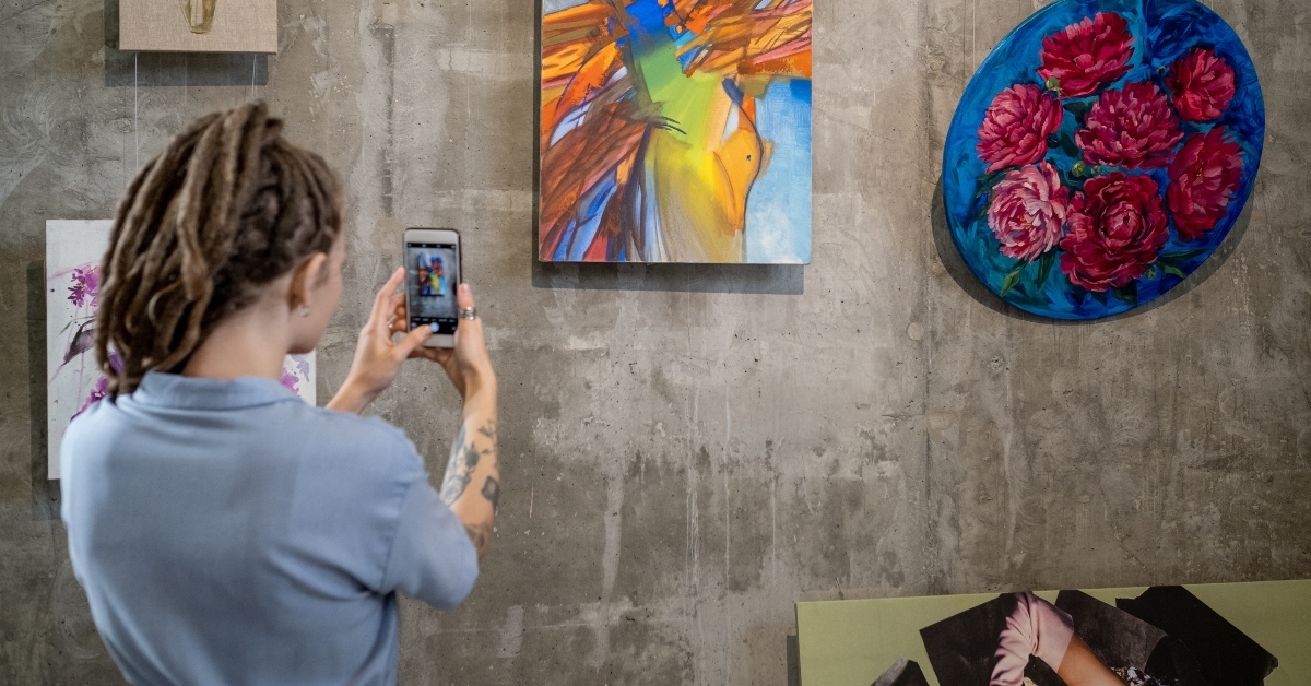 woman photographing painting