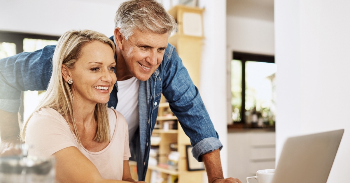 happy mature couple using laptop