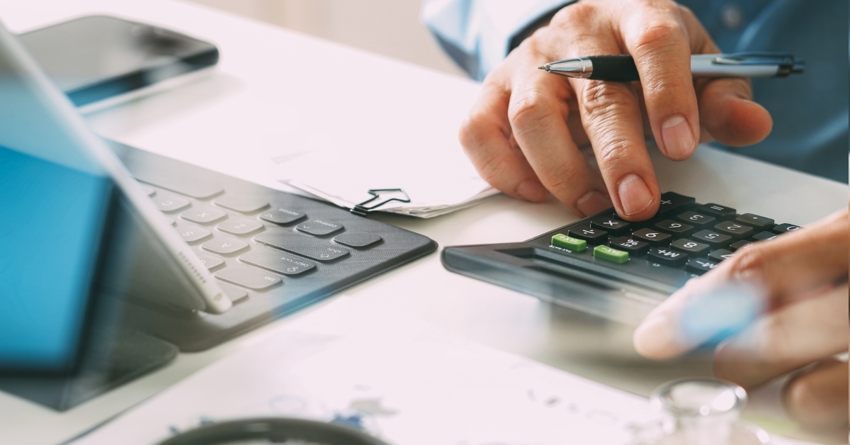 man calculating healthcare cost using calculator