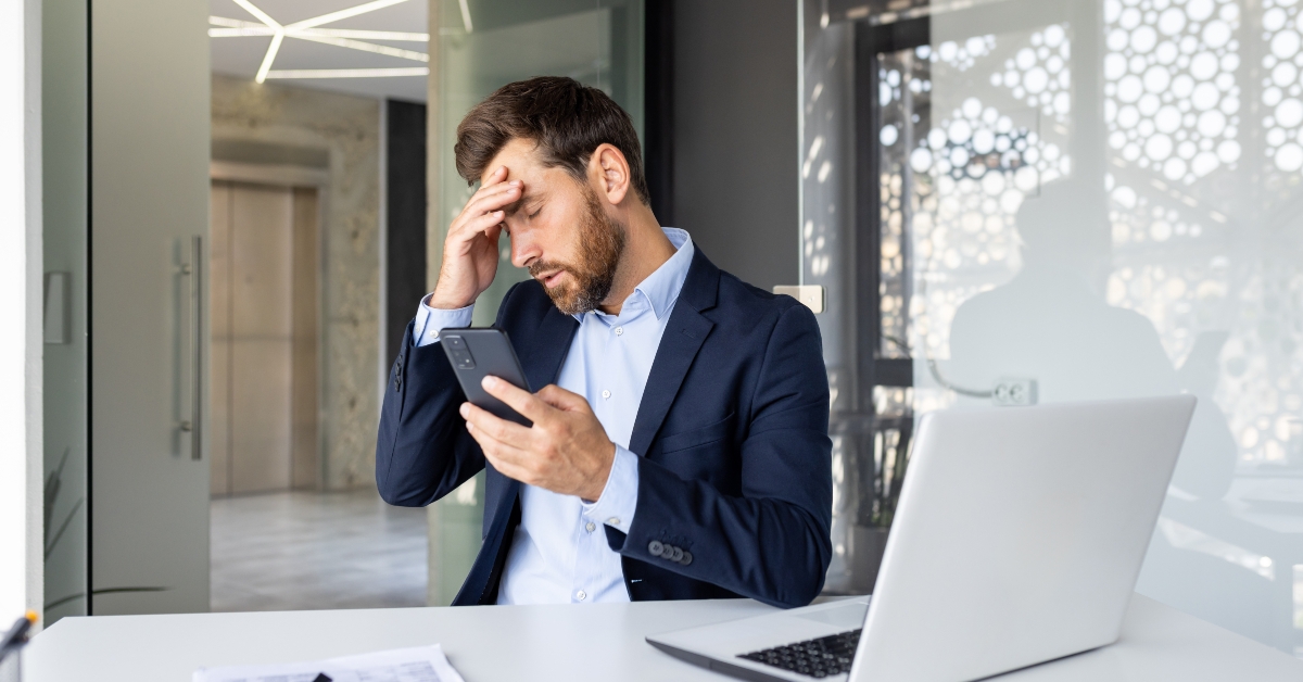 businessman sitting holding his head