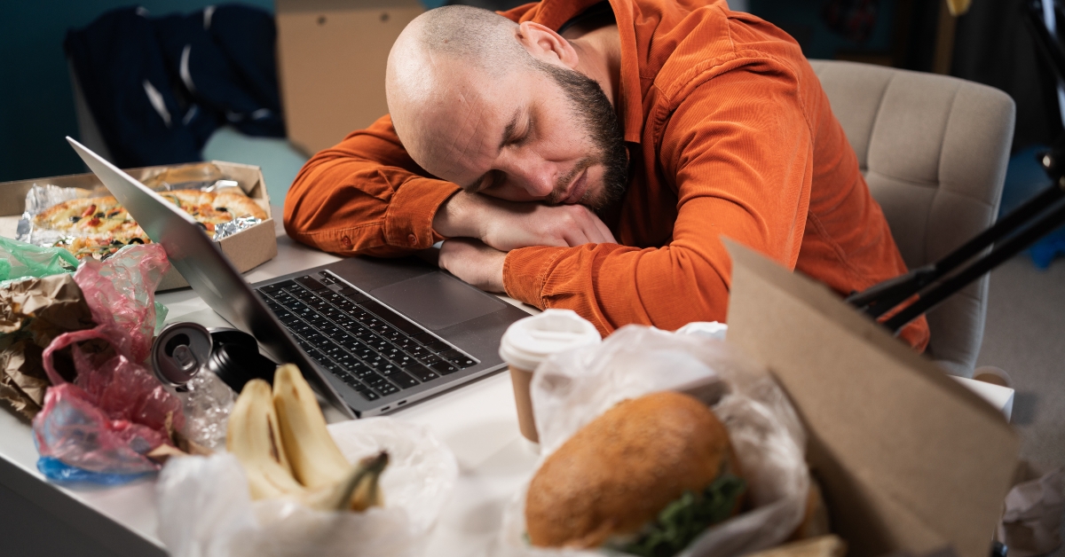 exhausted man sleeping on desk