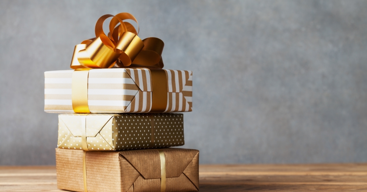 golden present boxes on wooden table
