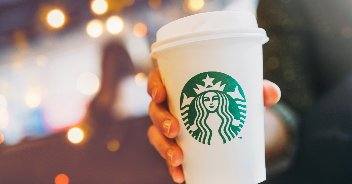 woman holding starbucks coffee in hand