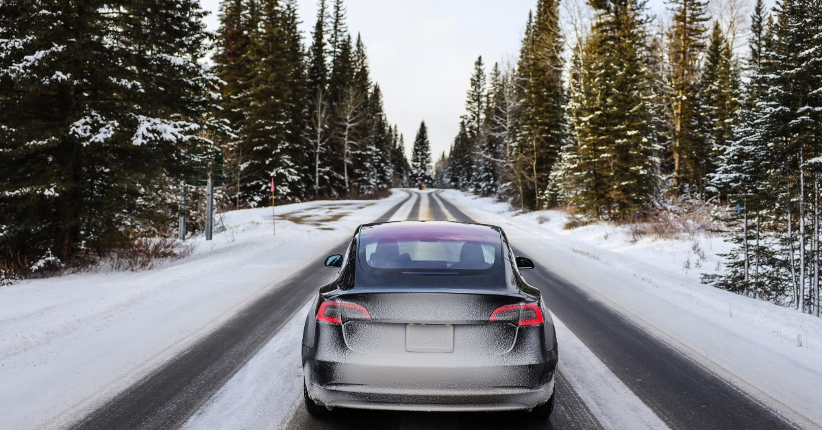 electric car driving on snowy road