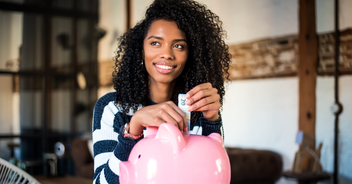 african american woman saving in piggy bank