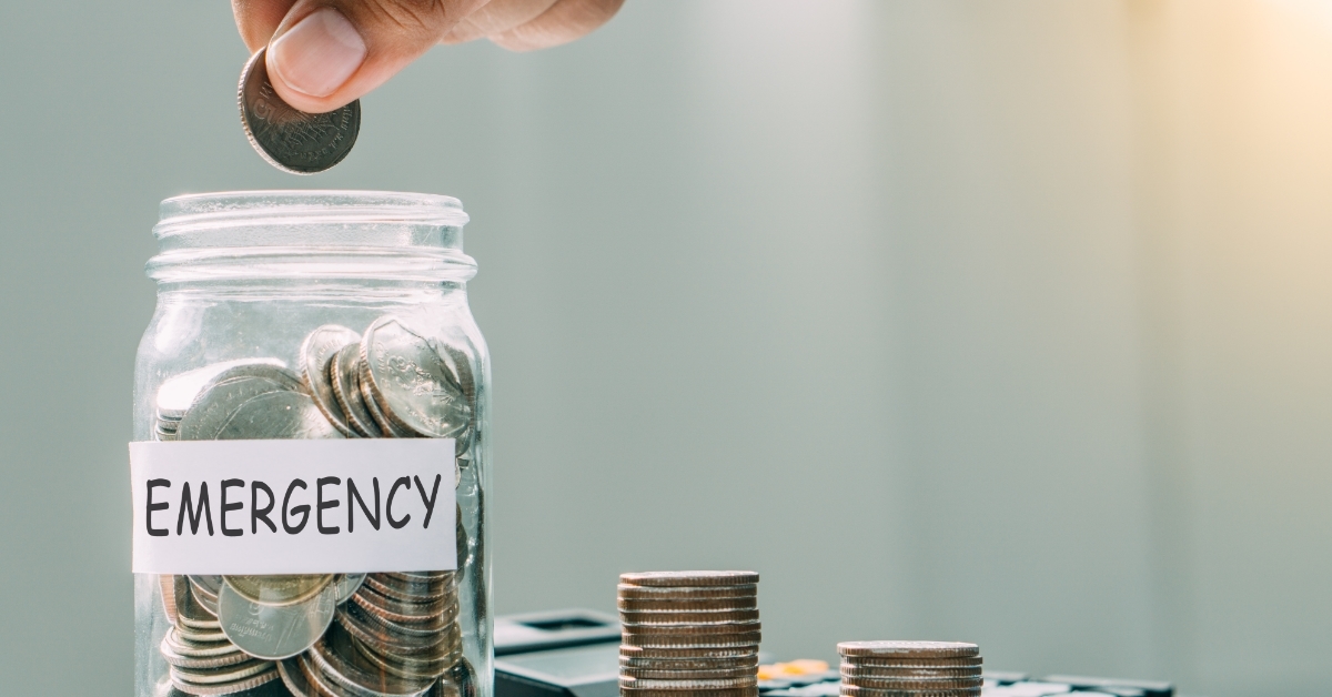 man filling emergency fund jar with pennies