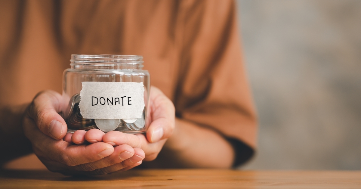 man holding jar with donate lable