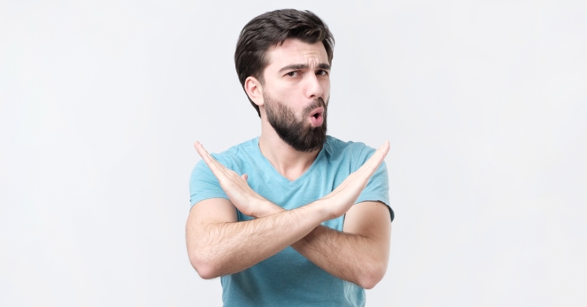 man doing no or stop sign