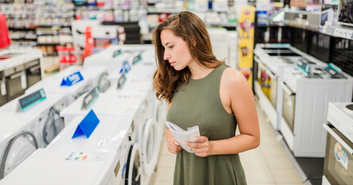 Woman buying washing machine at store
