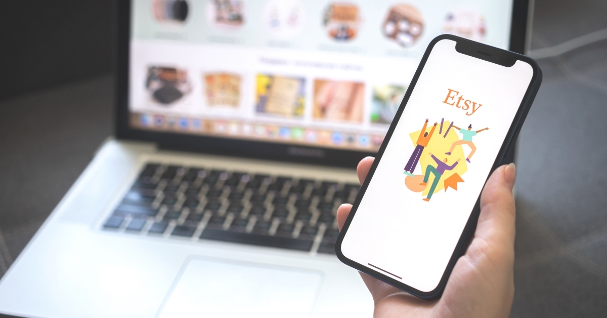 woman holding smartphone with etsy logo