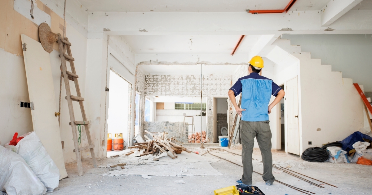 male worker inspecting house renovation