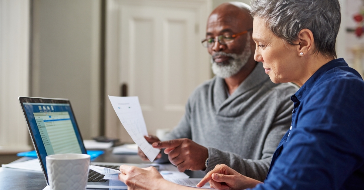 retired couple reviewing monthly budget 