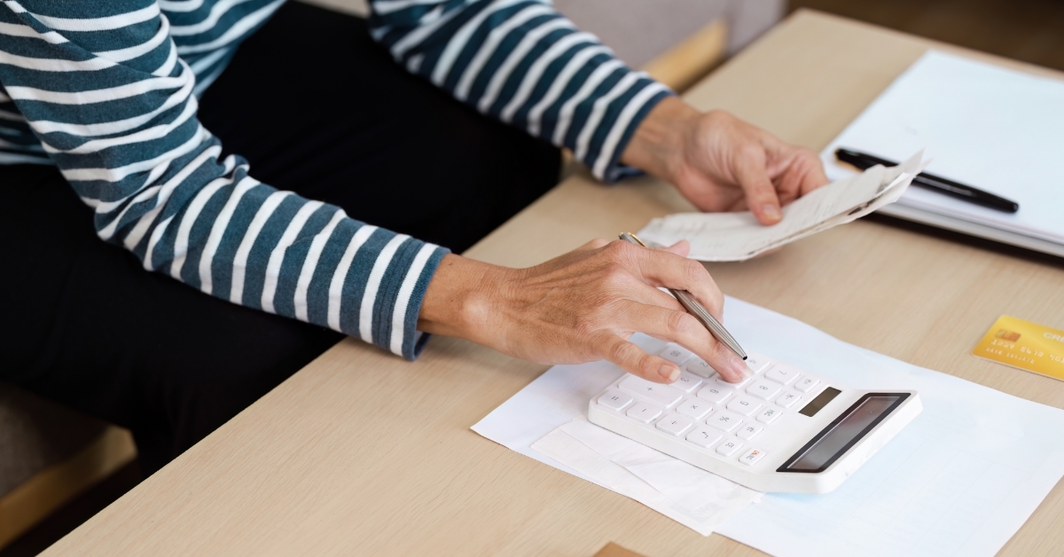 senior woman calculating budget at home