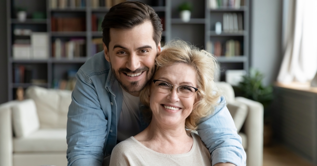 grateful adult son hugging senior mother