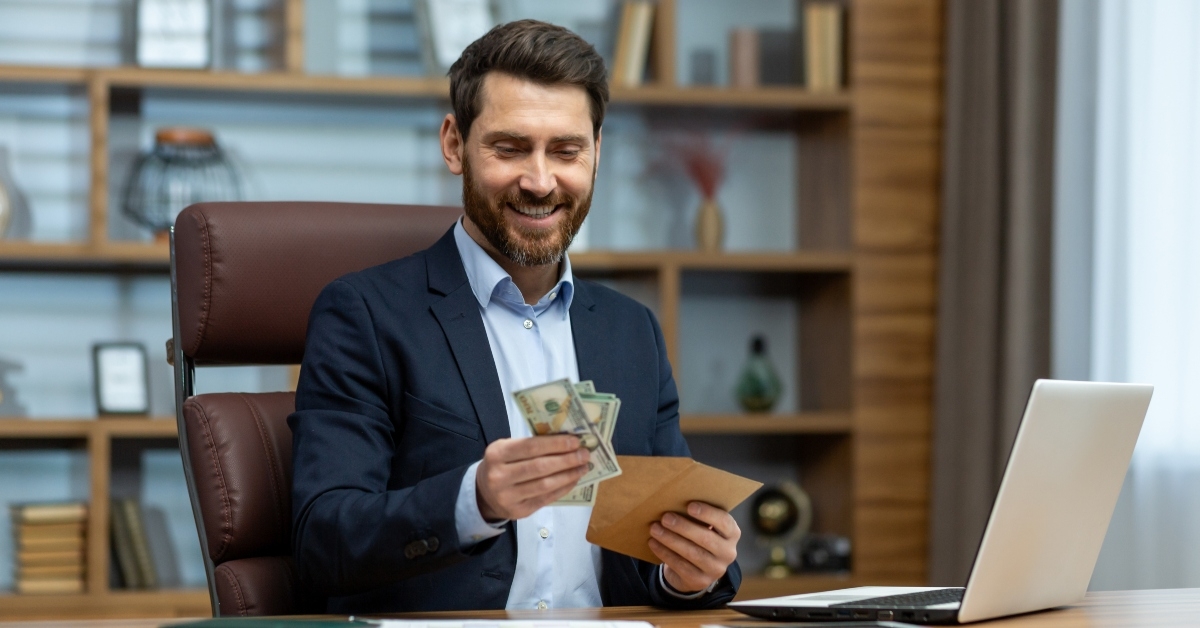 holding an envelope with cash