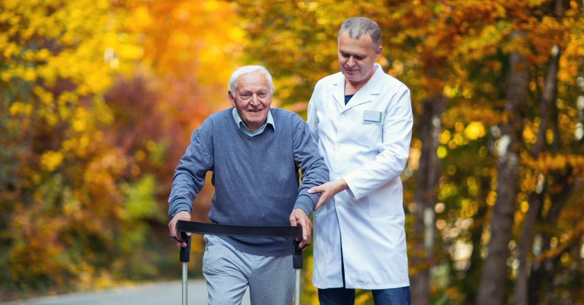 male nurse assisting senior patient outdoor