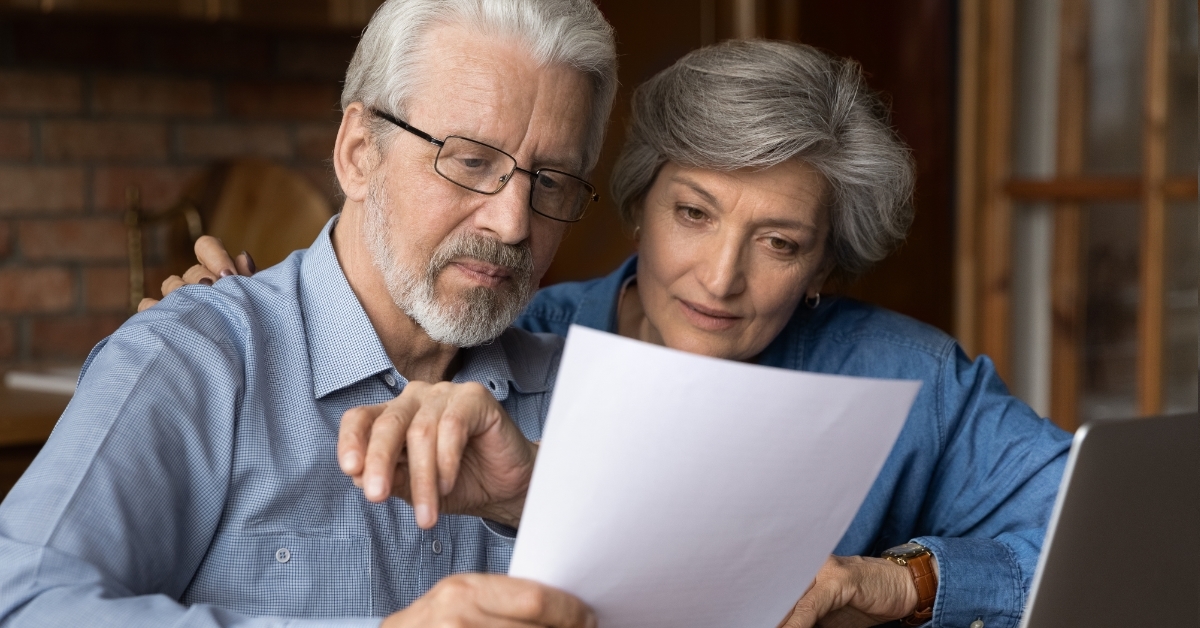 senior couple reviewing insurance policy together