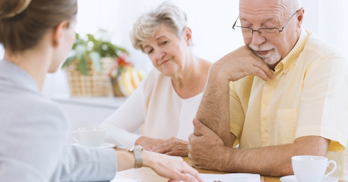 Senior couple signing life insurance