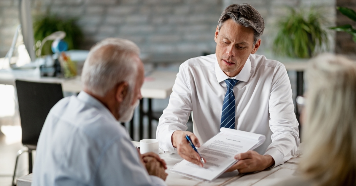 senior man analyzing insurance policy with agent