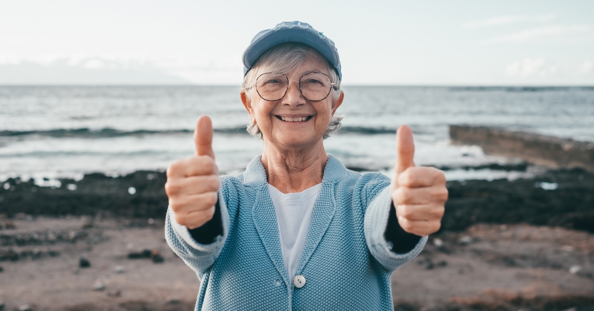 Senior woman with thumbs