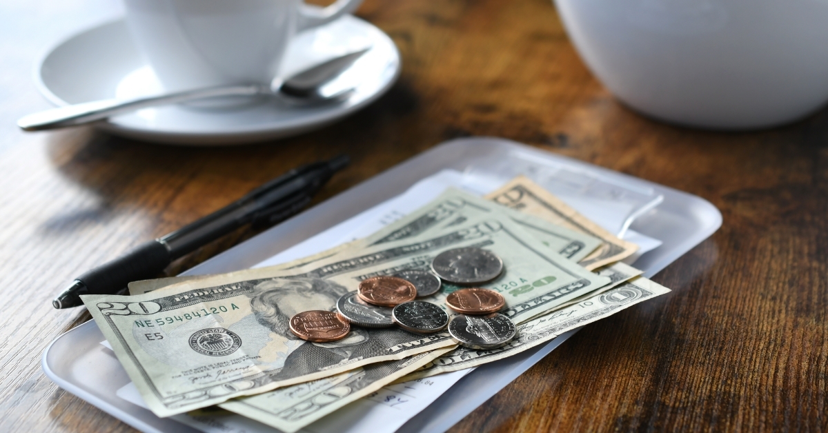 bill tab at cafe with cash money