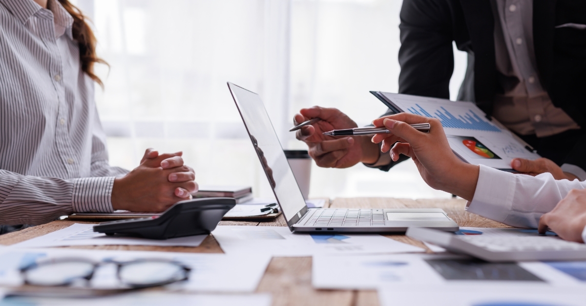 colleagues analyzing finance report together