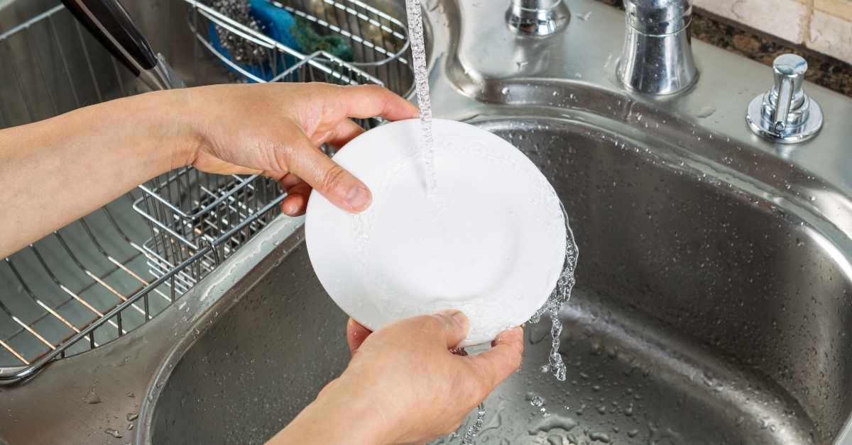 woman hands washing dinner plate