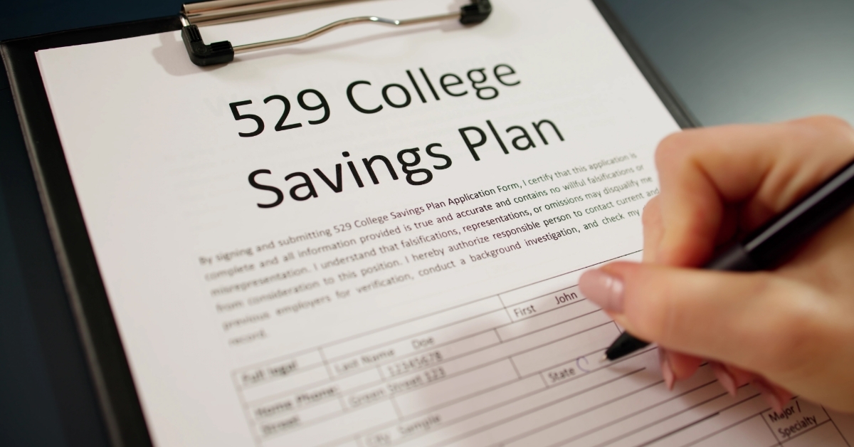 woman signing 529 college savings plan