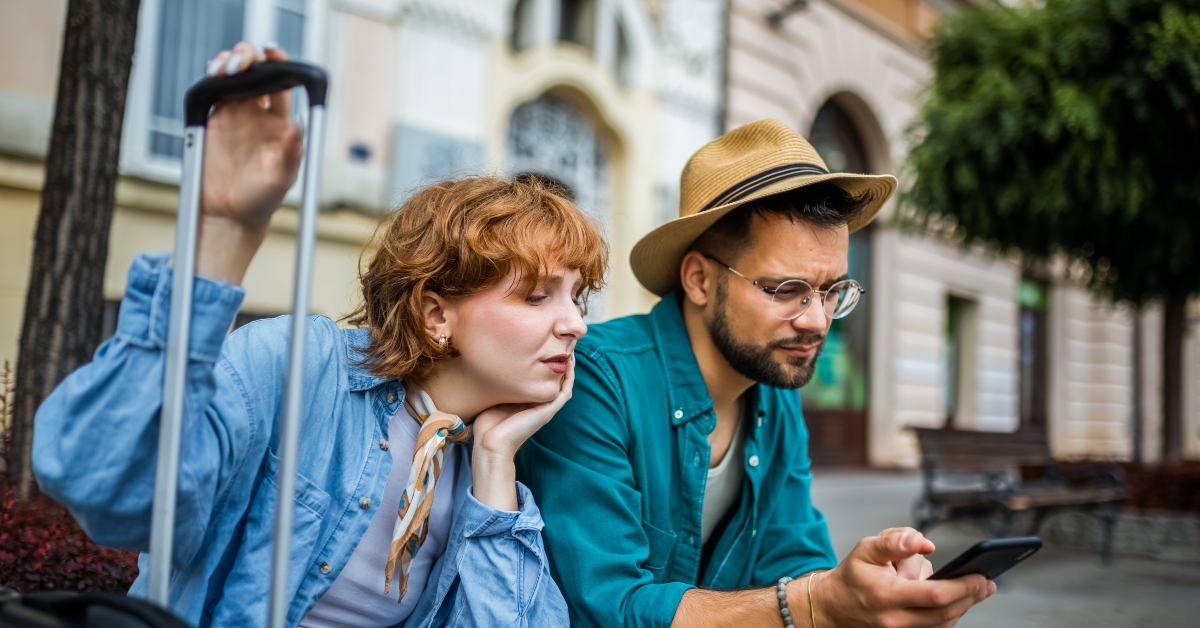 Tired couple sitting in city