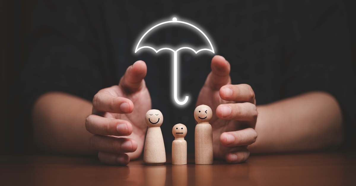 Two hands protecting wooden family