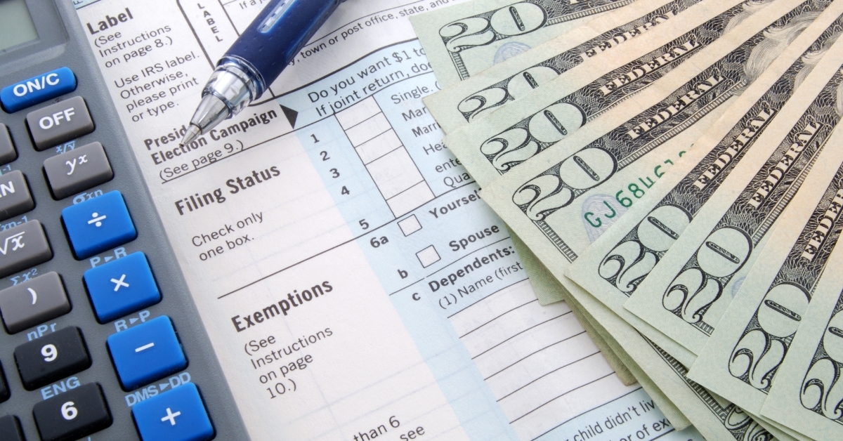 banknotes and calculator over bill