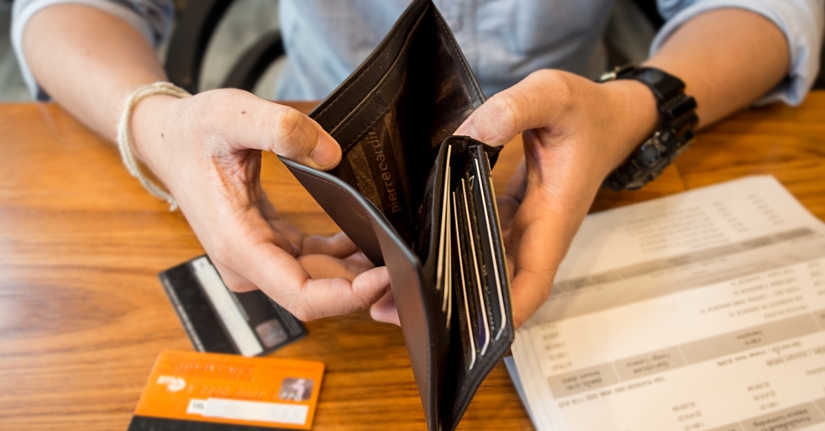man showing empty wallet debt concept