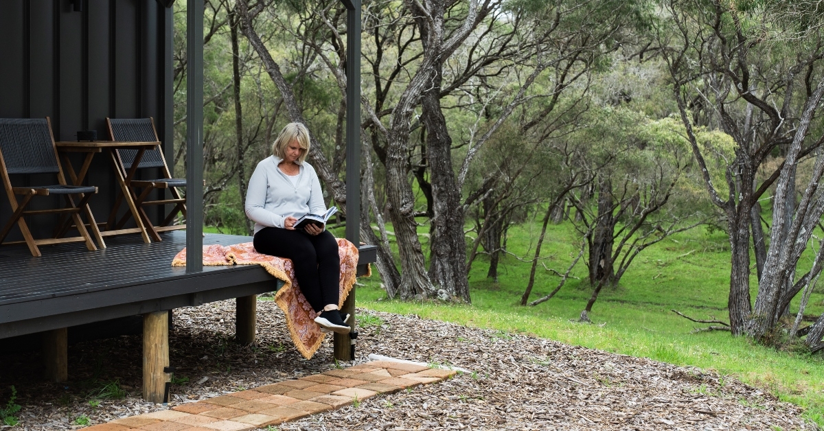 reading a book on the deck
