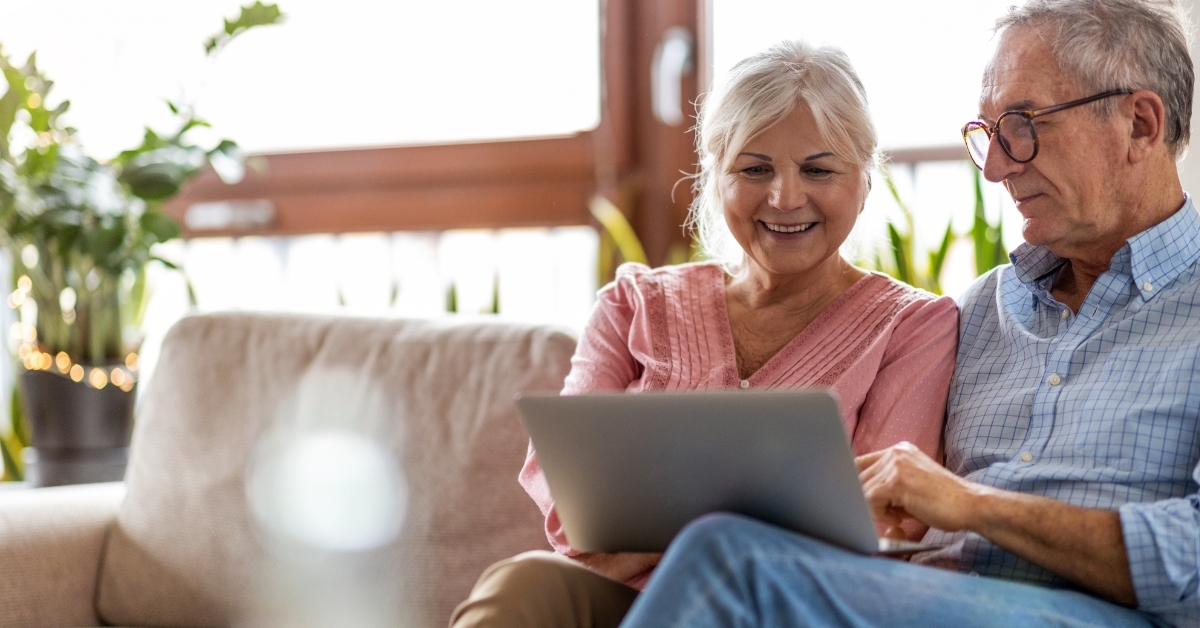 senior couple reviewing taxes using laptop