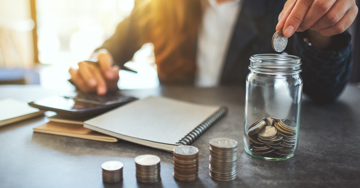 Businesswoman stacking coins