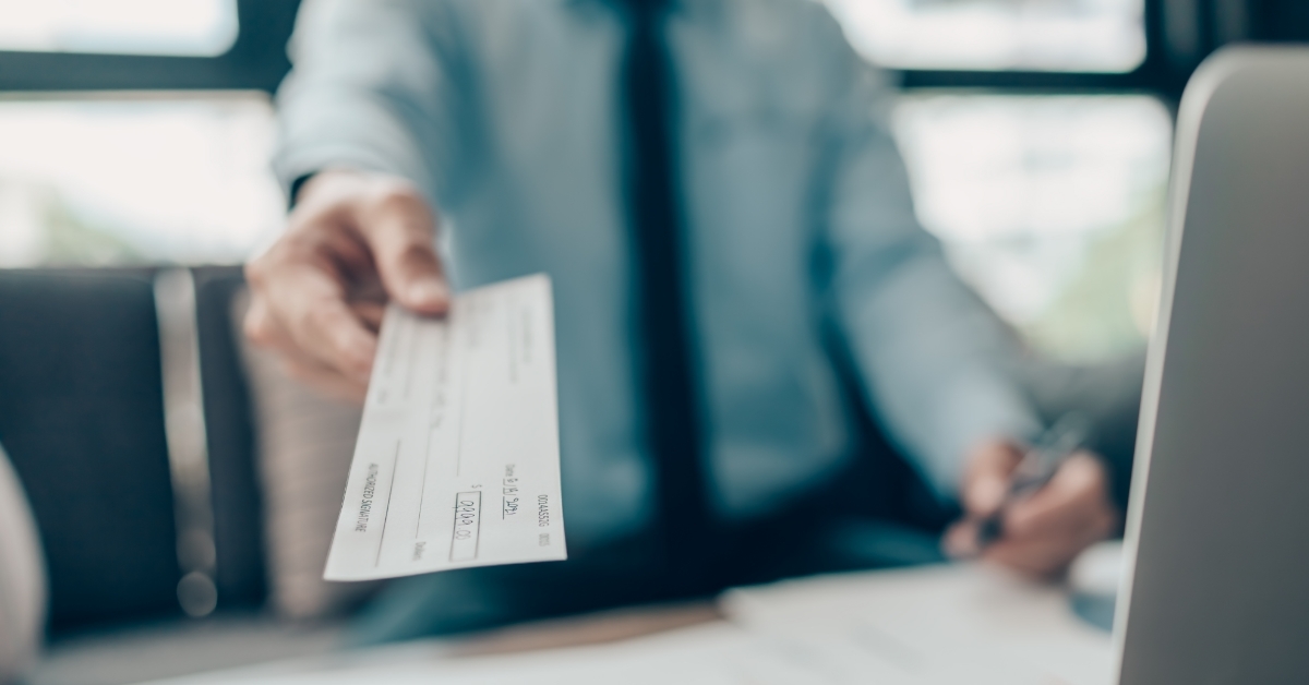 business man giving cheque to customer