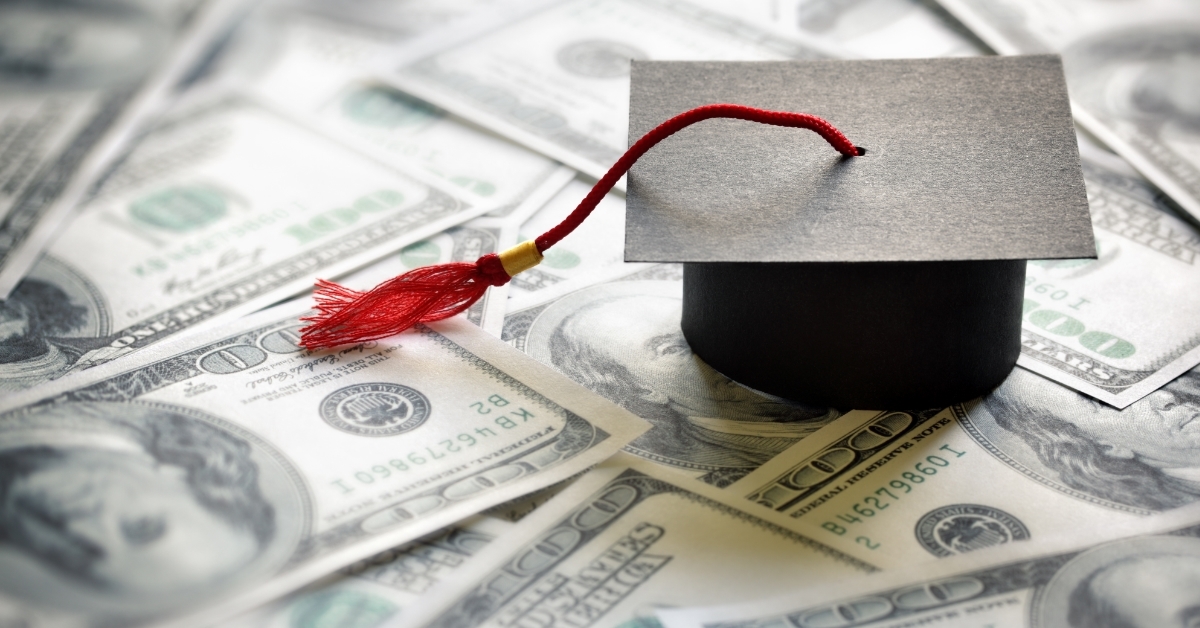 graduation hat on money education loan concept