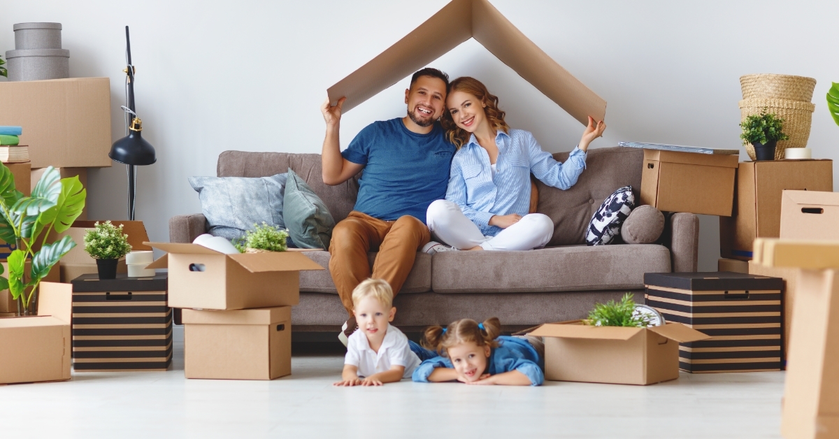happy family unpacking boxes at new home