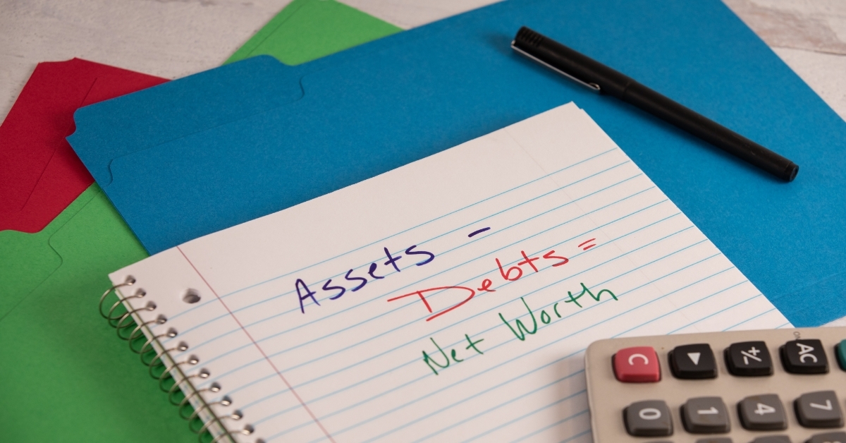net worth accounting equations on notebook