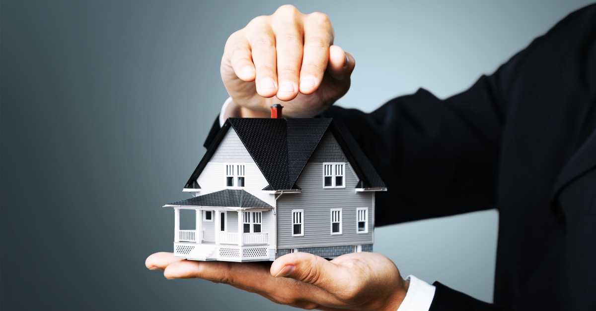 hands holding house model