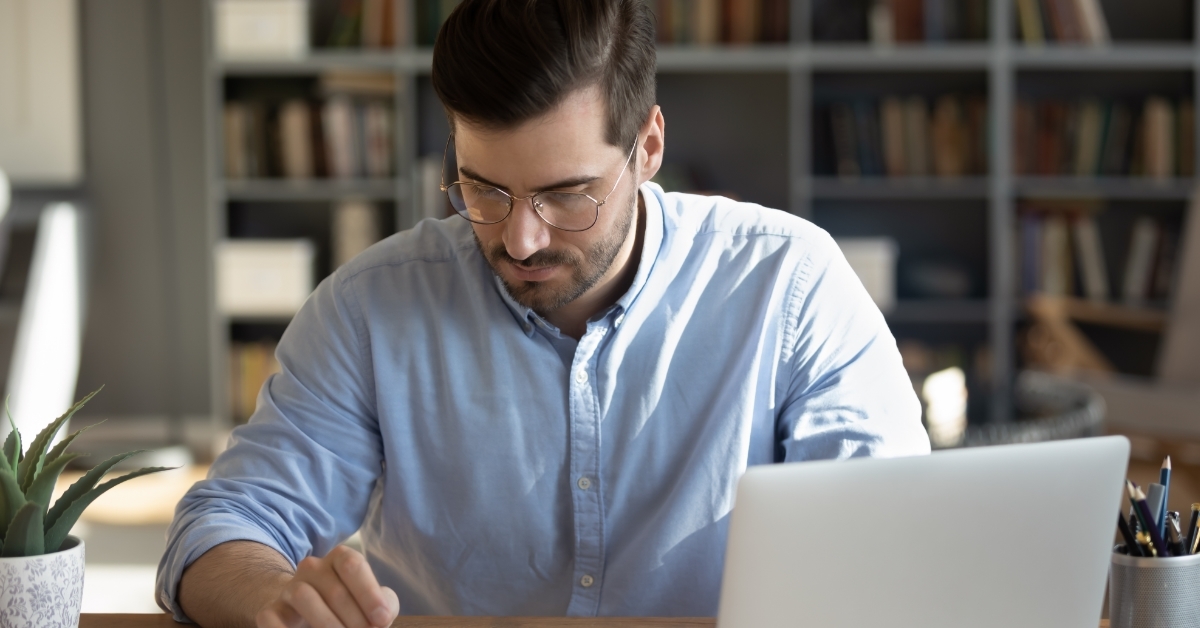businessman using calculator while working from home