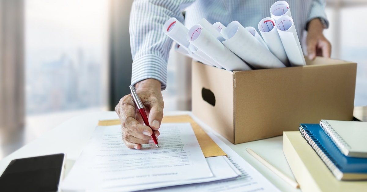 man resigning while packing things