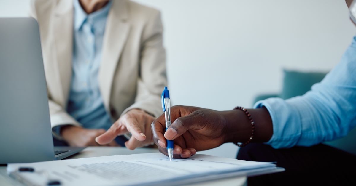 african american man signing insurance contract