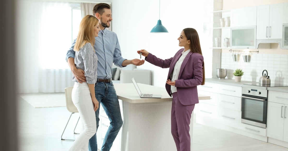 couple receiving house keys from realtor