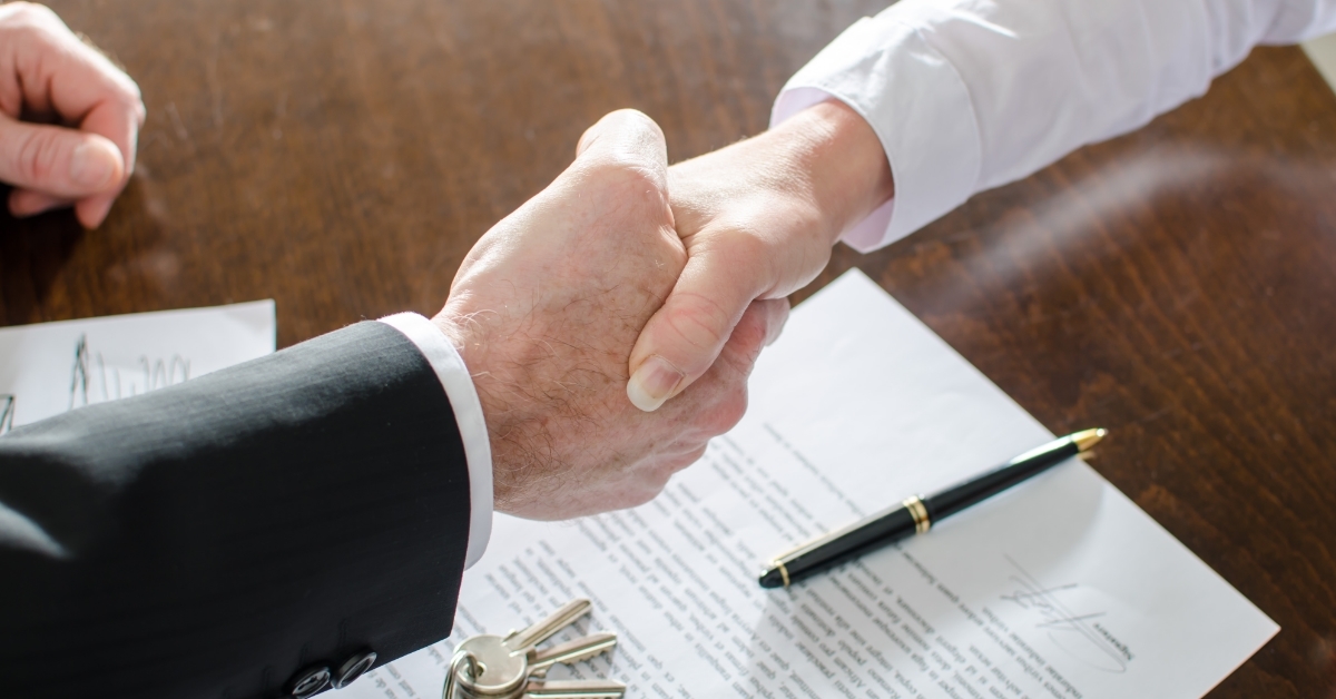 Estate agent shaking hands with customer