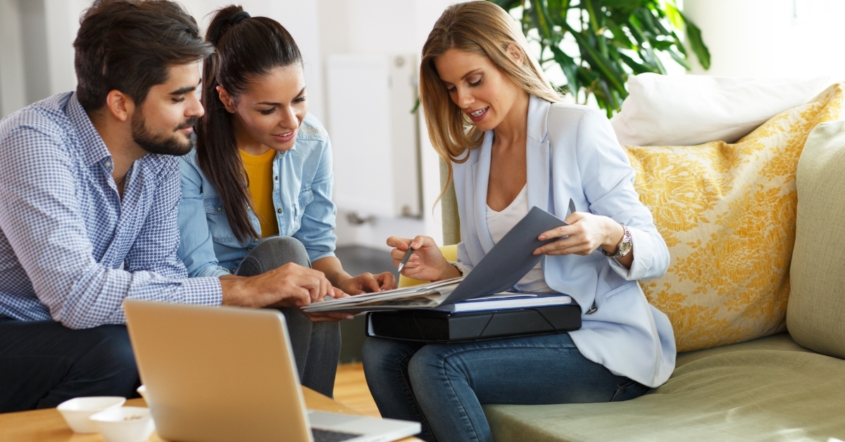 realtor explaining insurance policy to couple
