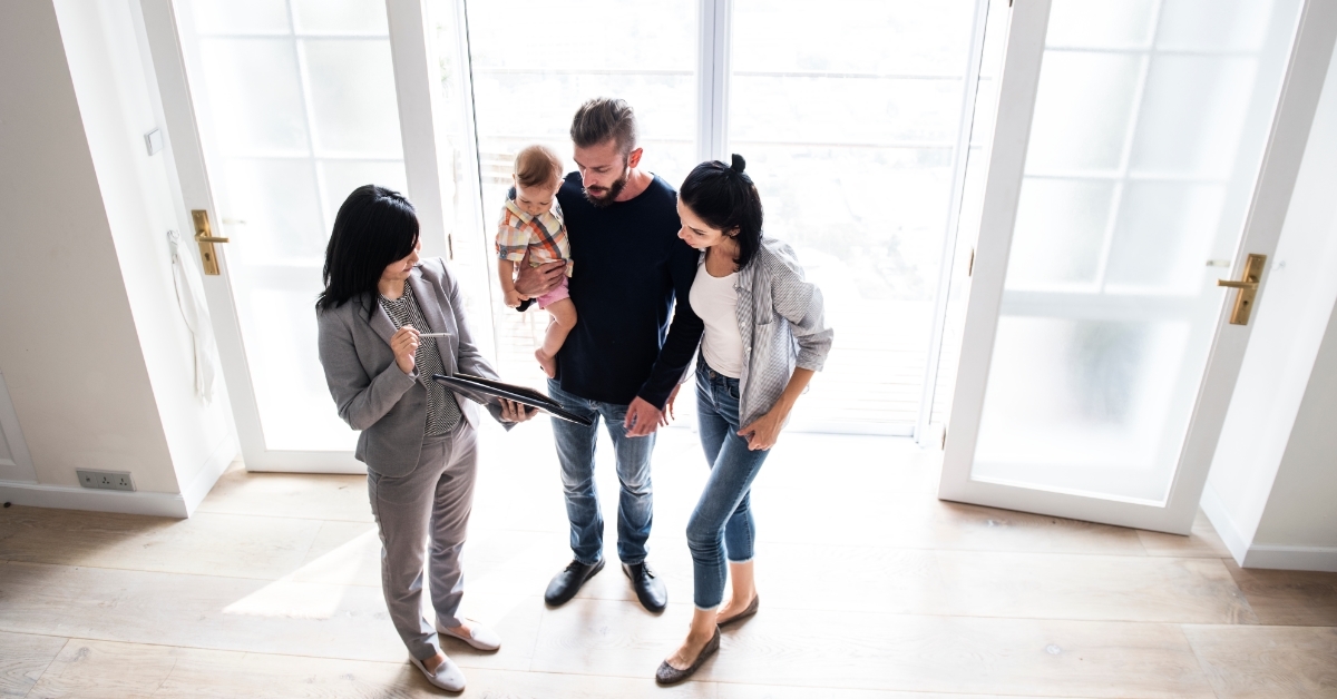 realtor showing contract to family buying house