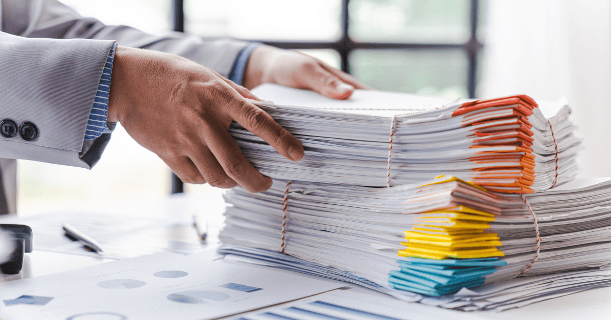 Stack of documents, pile of papers on office desk